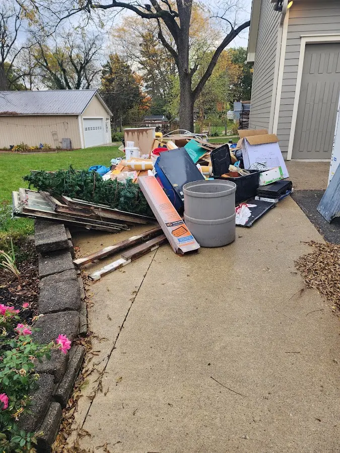 Dumpster being loaded with debris for Roofing Dumpster Rental in Towamensing